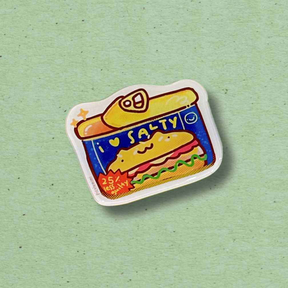 Colorful magnet of a sandwich in a can labeled 'Salty' on a light green background
