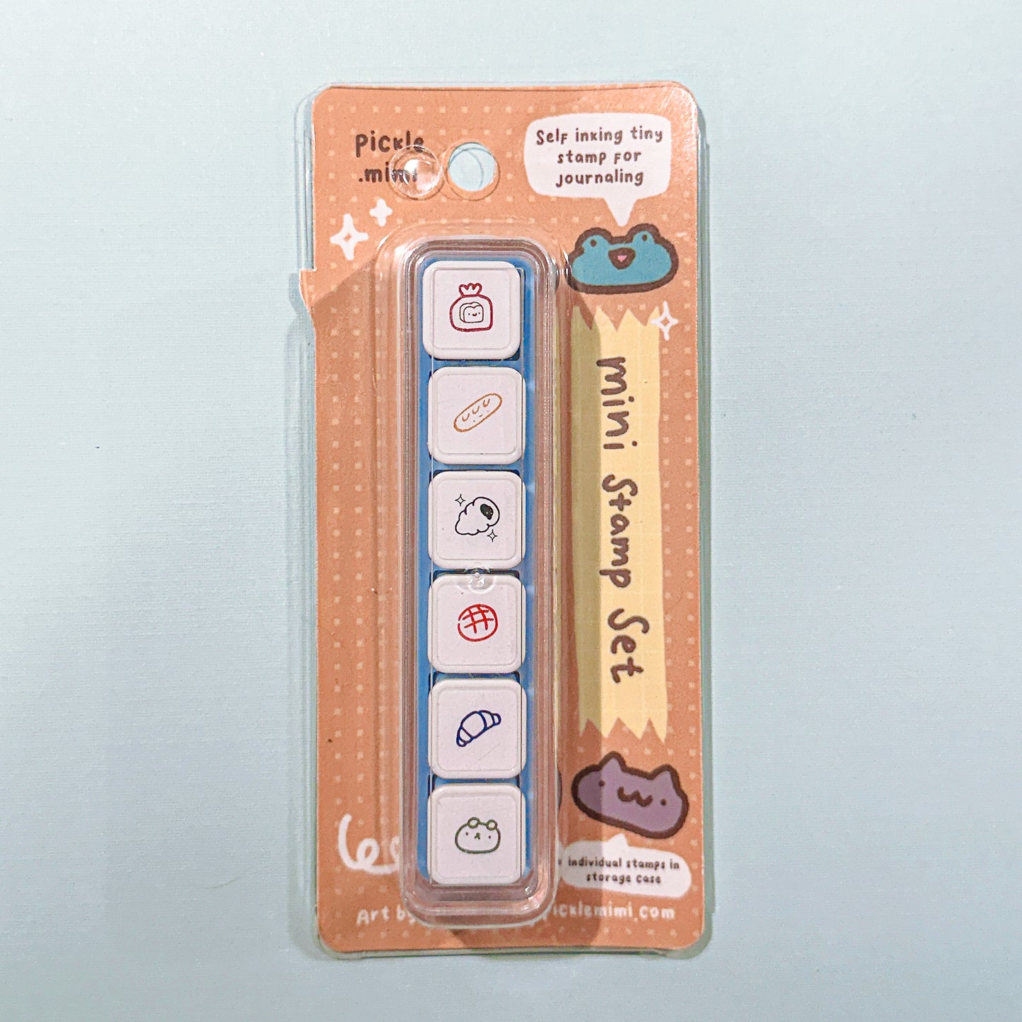 Mini stamp set in packaging with cute bread pastry designs on a light gray background