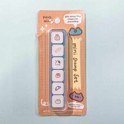 Mini stamp set in packaging with cute bread pastry designs on a light gray background