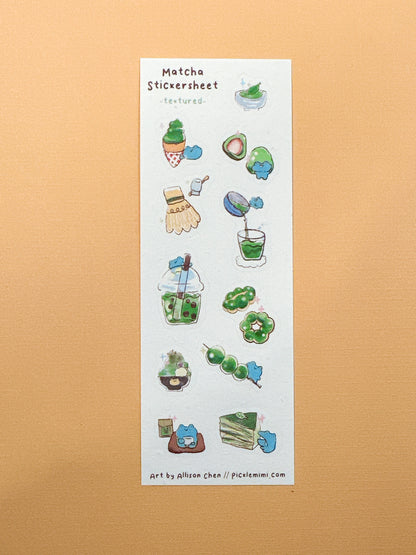 Sheet of matcha-themed stickers on a textured beige background
