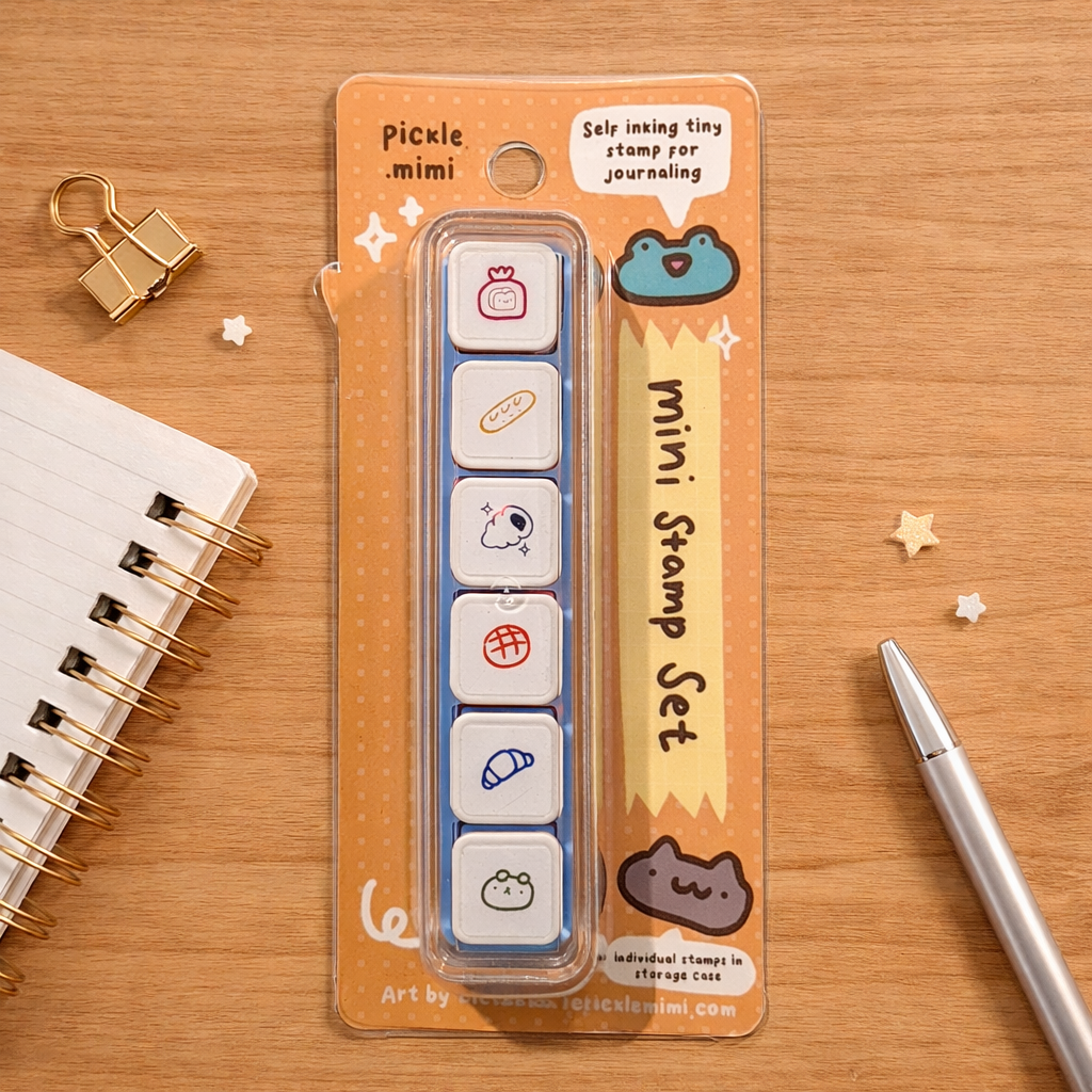 Pickle mimi mini stamp set packaging on a wooden surface with stationery items.